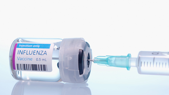 a syringe and a flu shot 