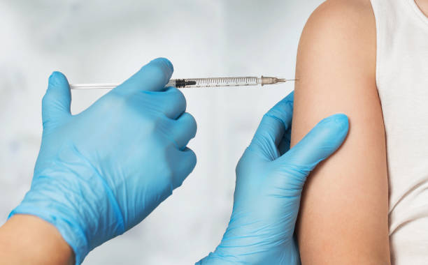 a physician administering a flu shot to a patient. OBGYN Associates of WNY is offering free flu shots to all patients at all locations this flu season. 