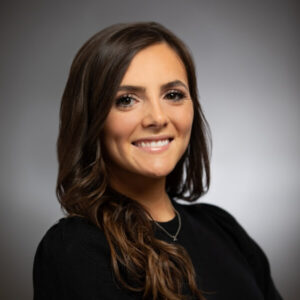 Nicole Fazzolari, a smiling young woman with dark hair